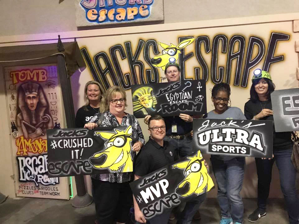 escape room winners holding signs at jacks fun things to do