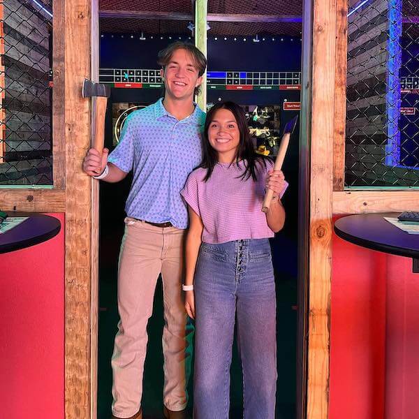 couple posing after playing axe throwing