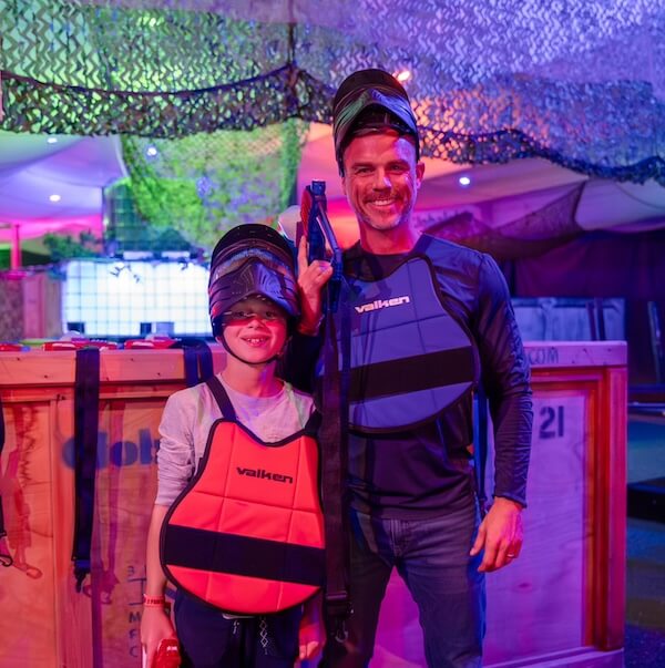 father and child in safety gear for gel blaster match