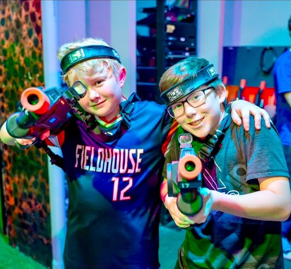 two boys with laser tag shooters