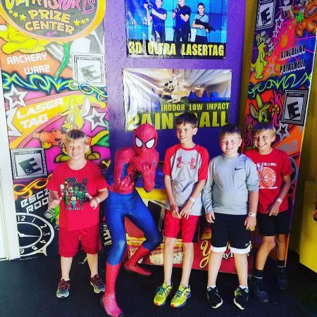 Kids birthday posing with spider man at Jack's Ultra Sports